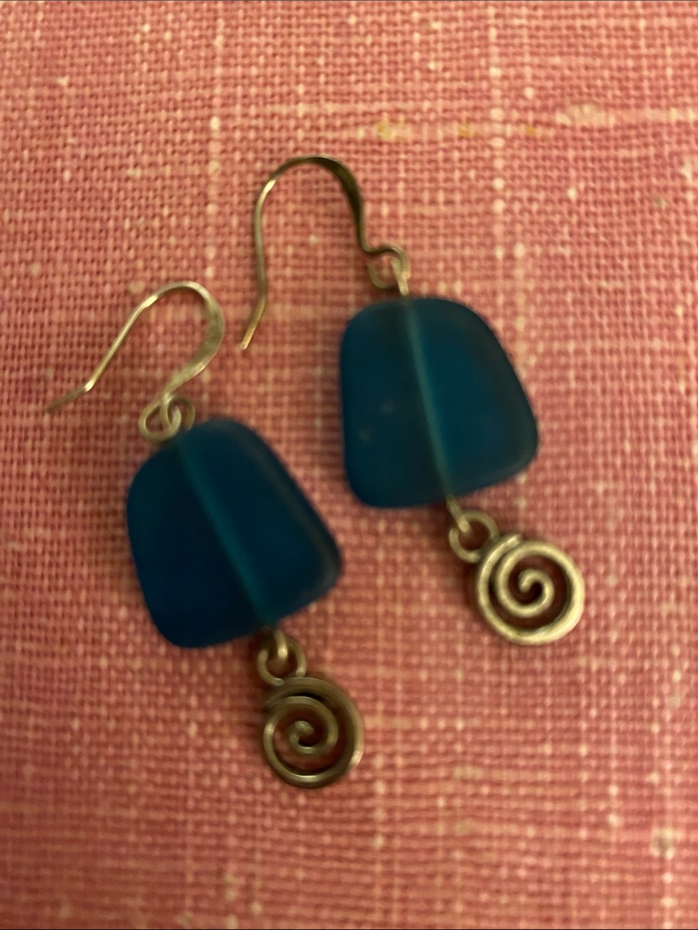 Teal sea glass dangle earrings with a spiral charm